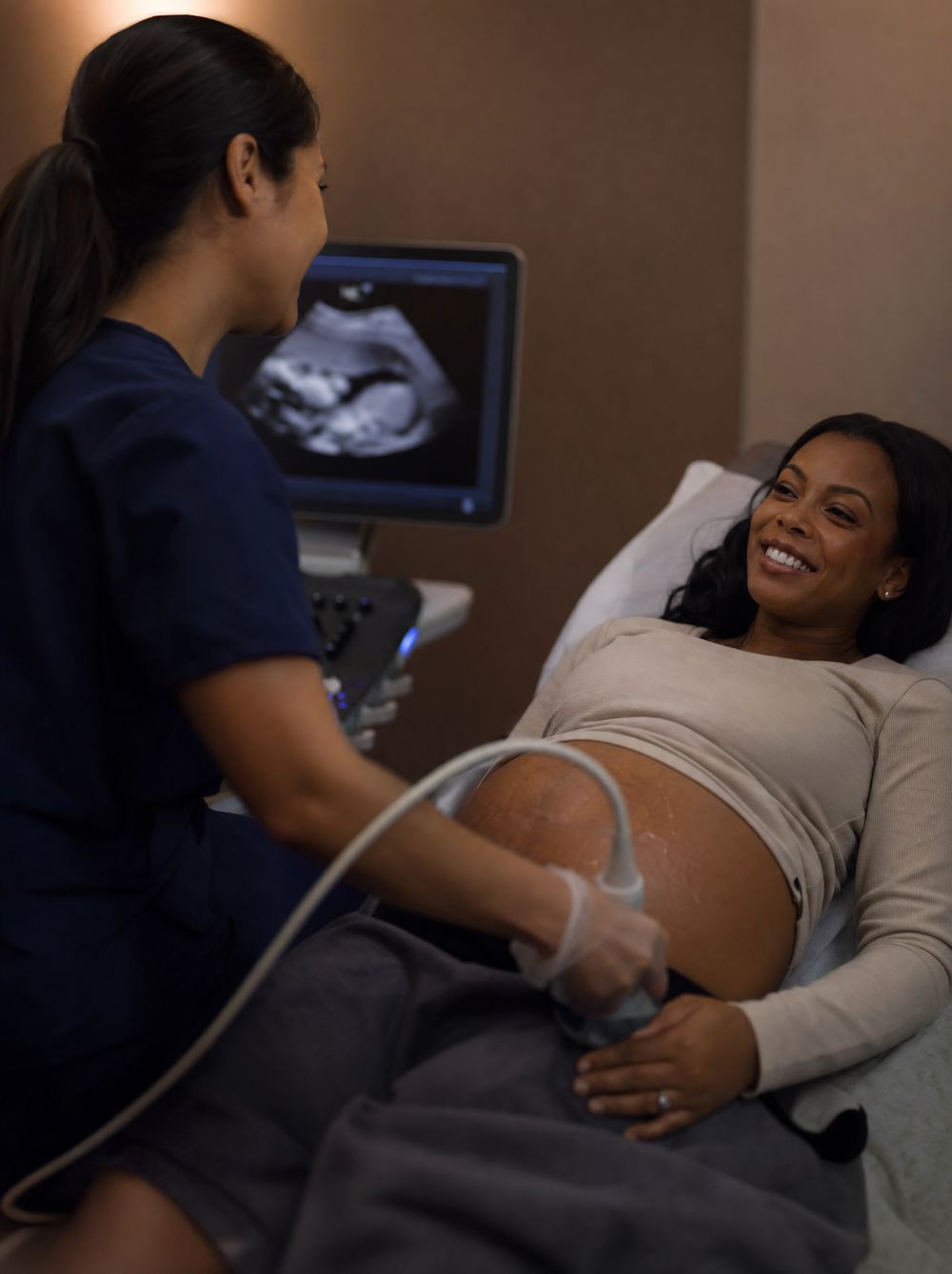 A sonographer performing an ultrasound for a pregnant patient